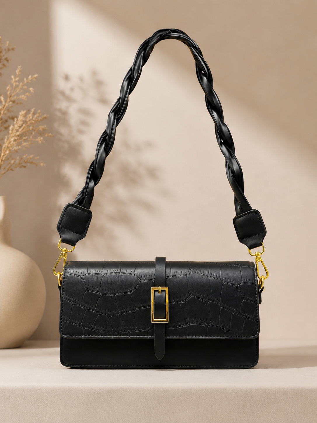 fashionable shoulder bag with twisted short belt and long strap. | black